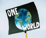 a sign celebrating earth day showing the words "one world"