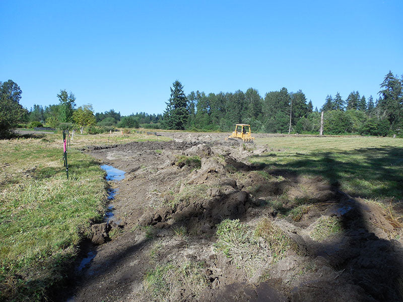 Plowing a strip of earth, to allow for the silt fence.