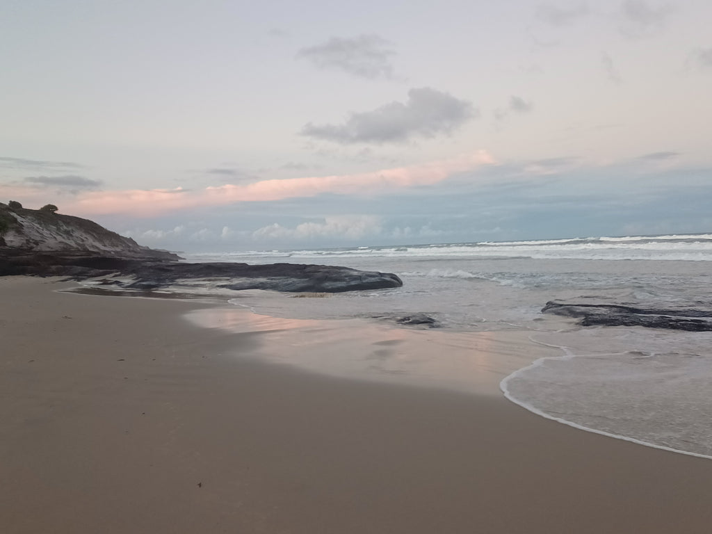 Australian beach black rocks