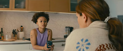 Leave the World Behind Ruth in lavender purple shirt in kitchen talking with Amanda