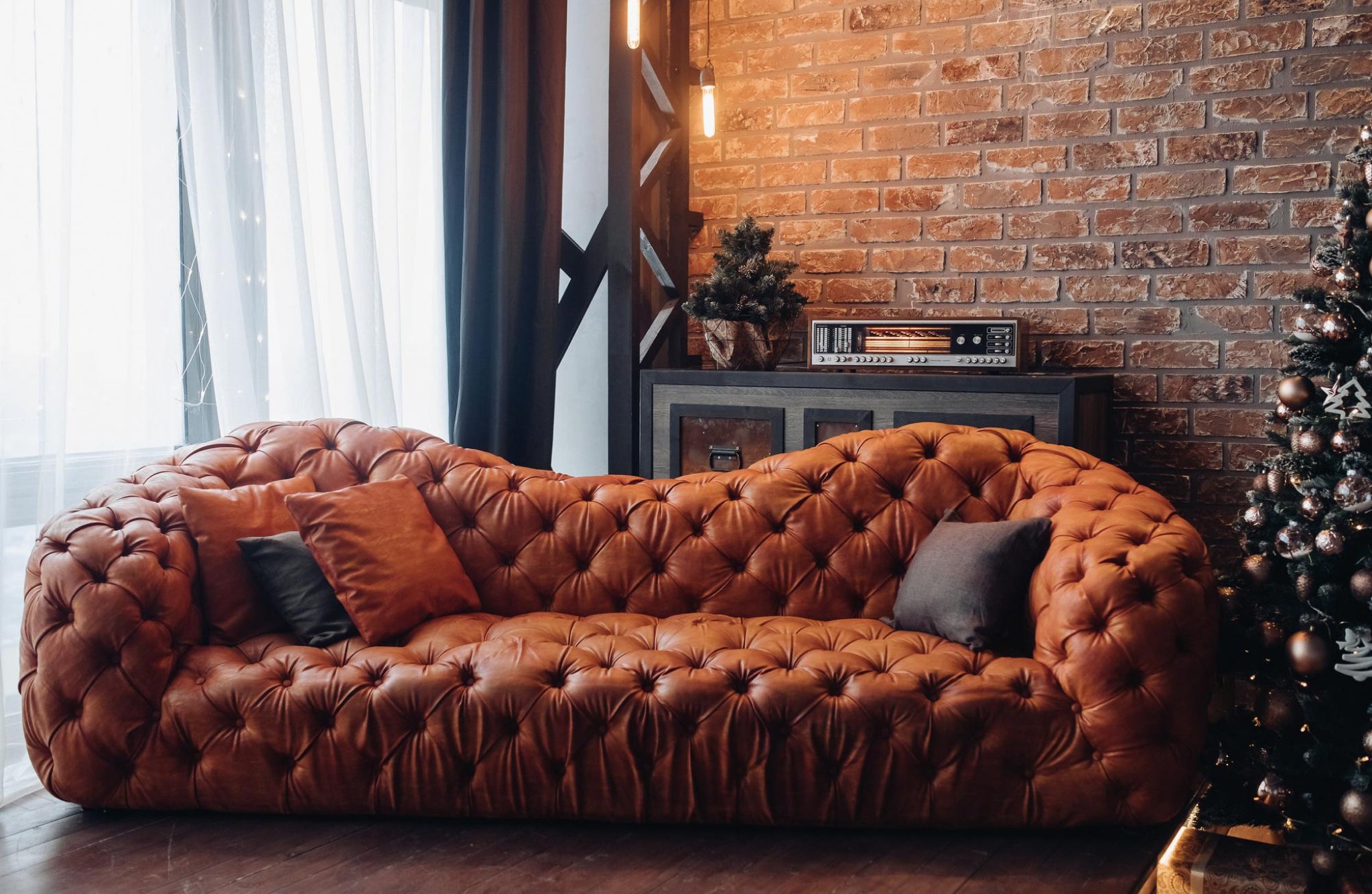 Brown vintage leather couch with cushions.