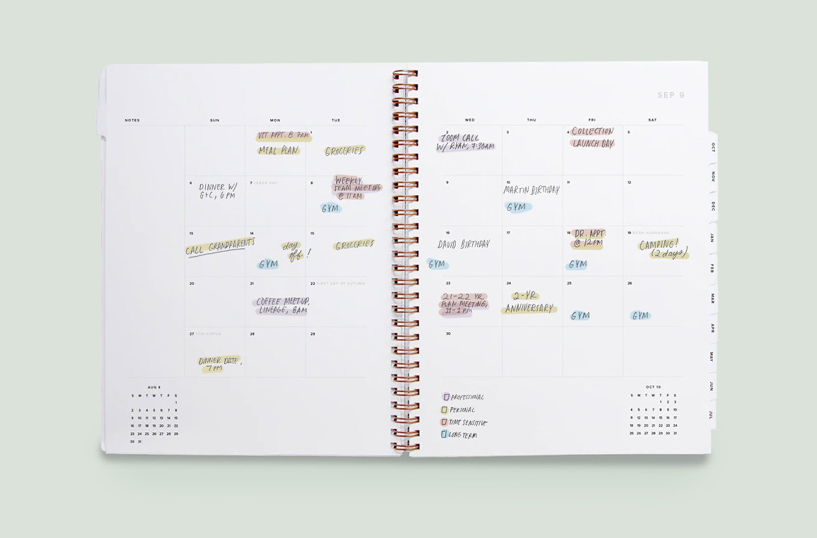 a year task planner lies open to the month spread, where tasks and appointments are color-coded with pastel highlighters.