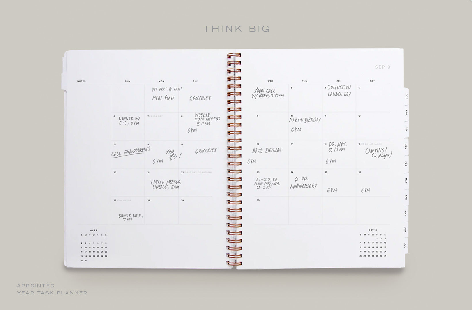 A Year Task Planner lays open to the month spread with appointments and events filled in