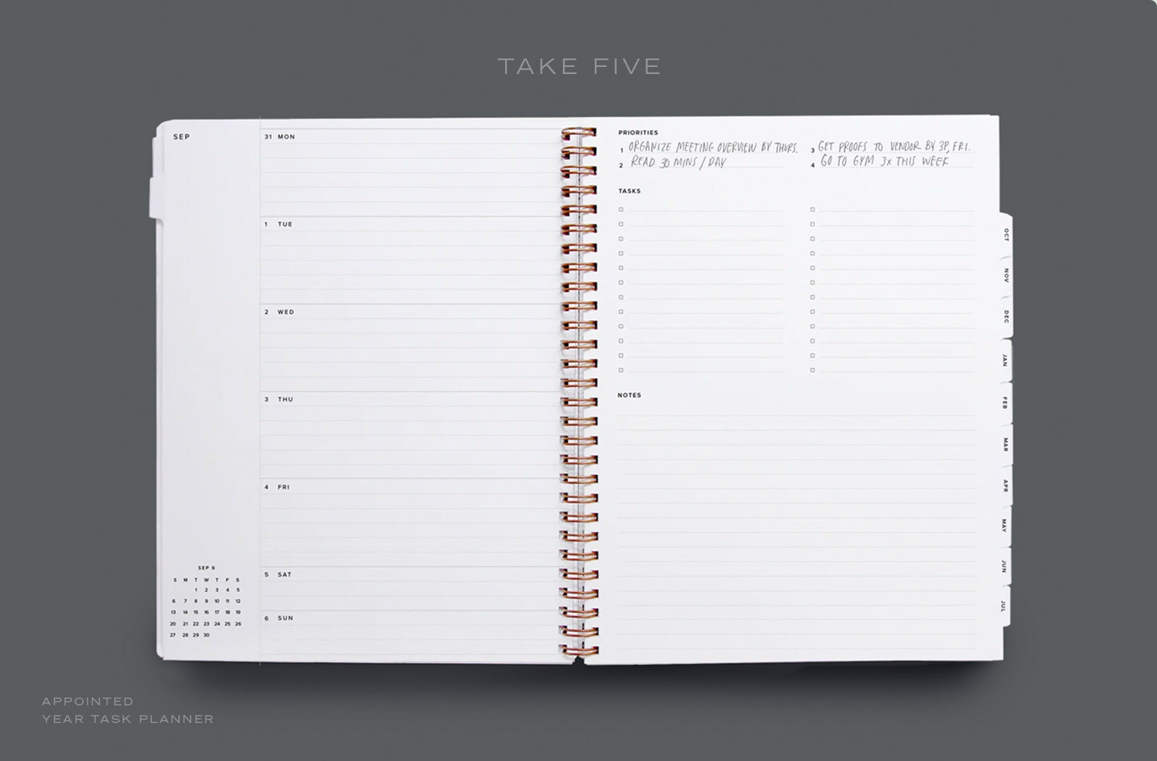 A Year Task Planner lies open to the weekly view, with weekly priorities filled in.