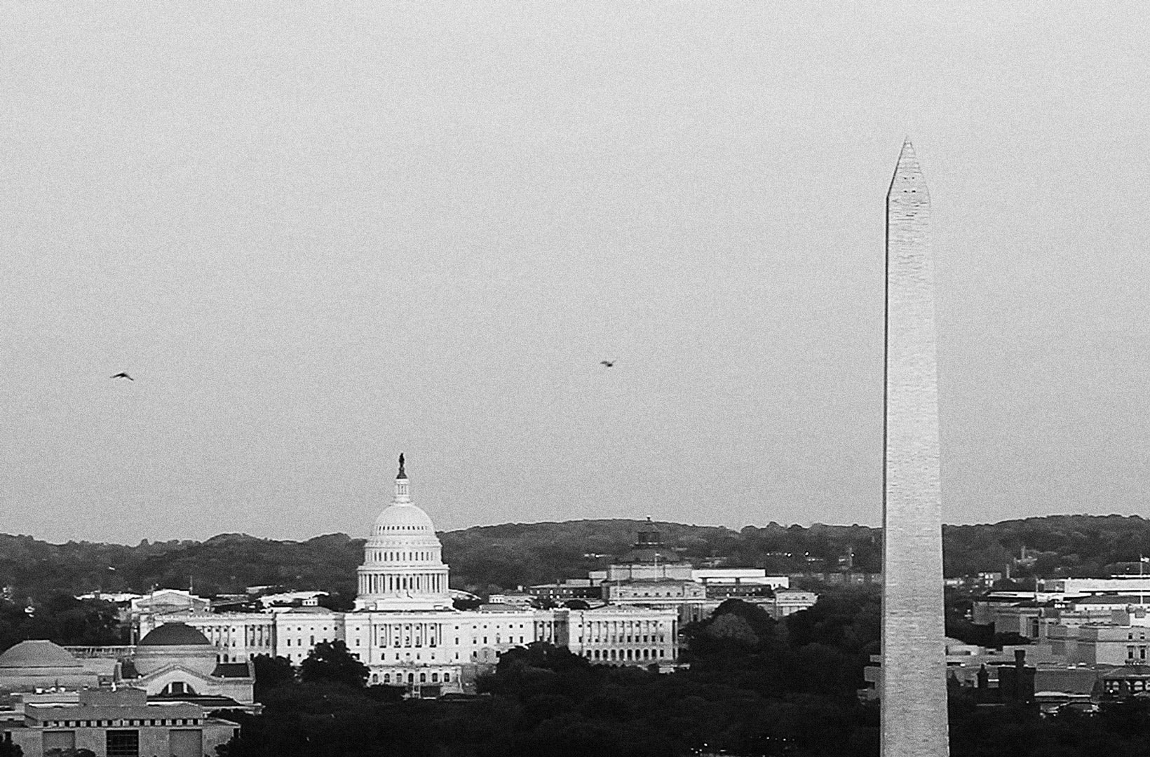 A Washington, D.C. aerial shot showing the Capitol Building & Washington Monument in black and white