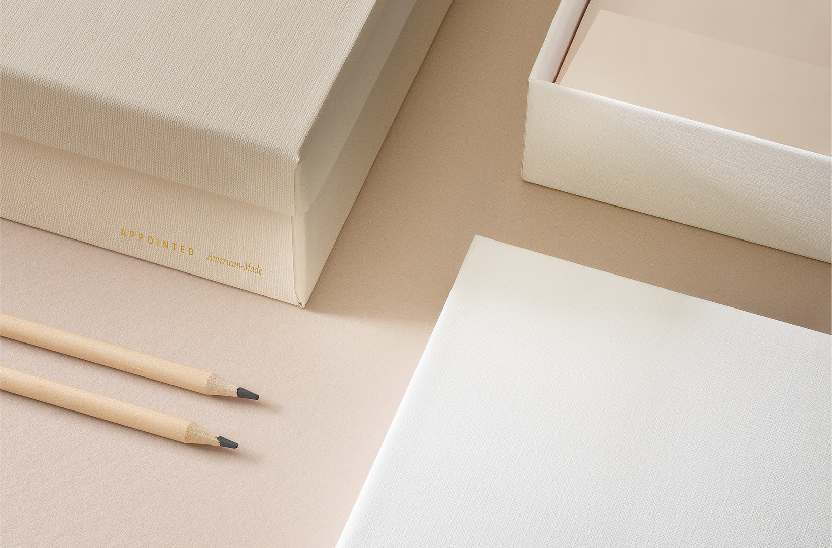 the appointed storage box set is open on a light beige background with pencils aside.