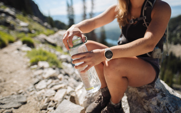 Woman hiking with Recon water bottle