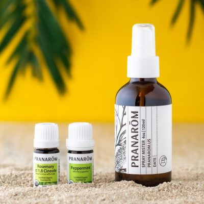 Pranarom Certified Organic Rosemary ct 1,8 Cineole Essential Oil, Peppermint Essential Oil, and Spray Mister bottles with yellow background.