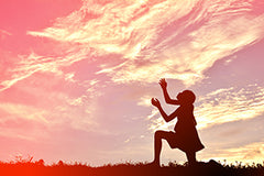 Woman praying looking up to the sky 