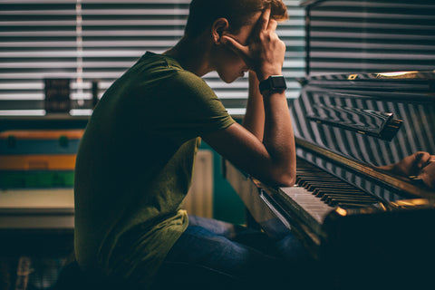 Young man struggling with piano practice