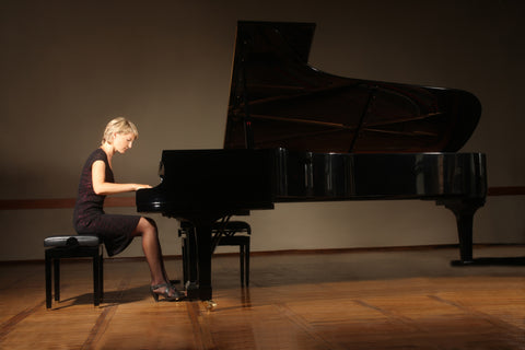 Woman sitting properly & playing piano