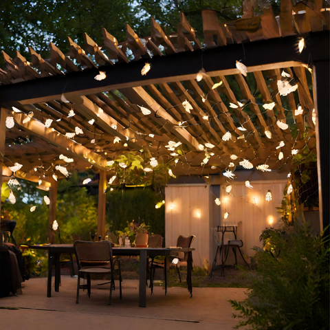 Biomimicry lights in the shape of delicate butterflies grace the ceiling of a patio pergola, providing imaginative inspiration for illuminating your outdoor sanctuary.