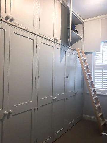 Integrated cupboards with open door using rolling ladder