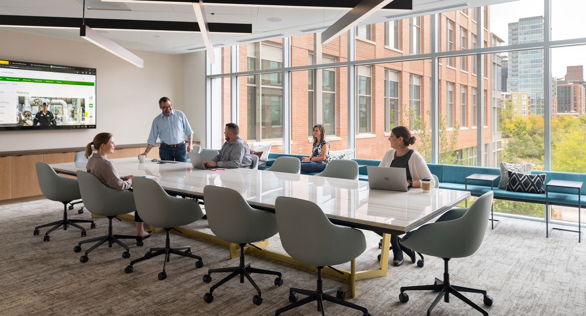 Employees collaborate together in well-designed conference room.