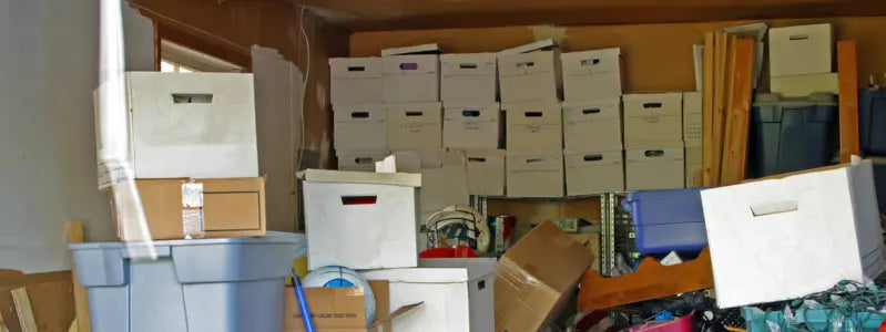 A cluttered garage with many boxes.