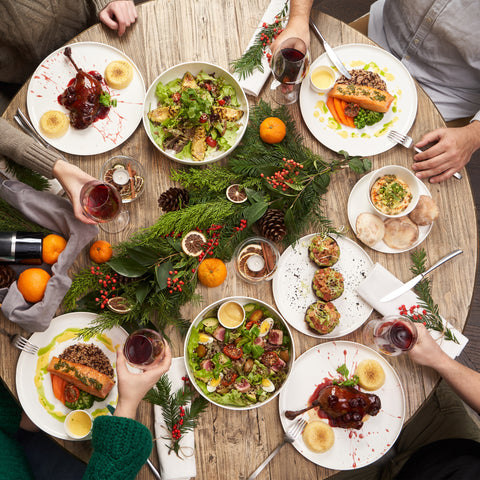 Dinner table with 4 people eating from a seasonal decorated table.  Cholesterol, eat healthy, lower cholesterol, Natural statin alternative.