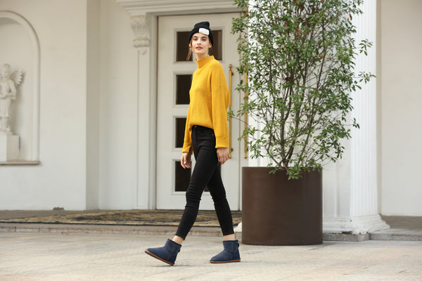 UGG Premium Mini Classic Boots with a model walking displaying the Navy Colour