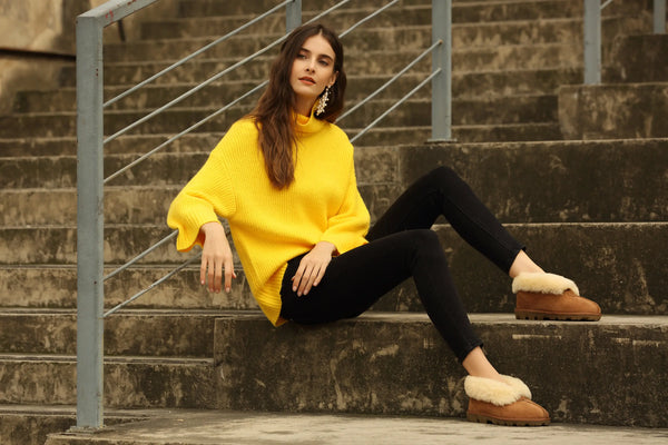 UGG Premium Sheepskin Classic Slippers on a female model displaying the Chestnut colour.