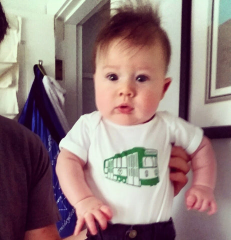 baby boy wearing Boston MBTA Trolley onesie