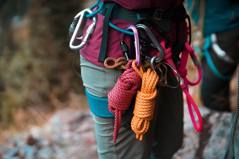 Rock climbers on a rock wall closeup. Climbing gear and equipment