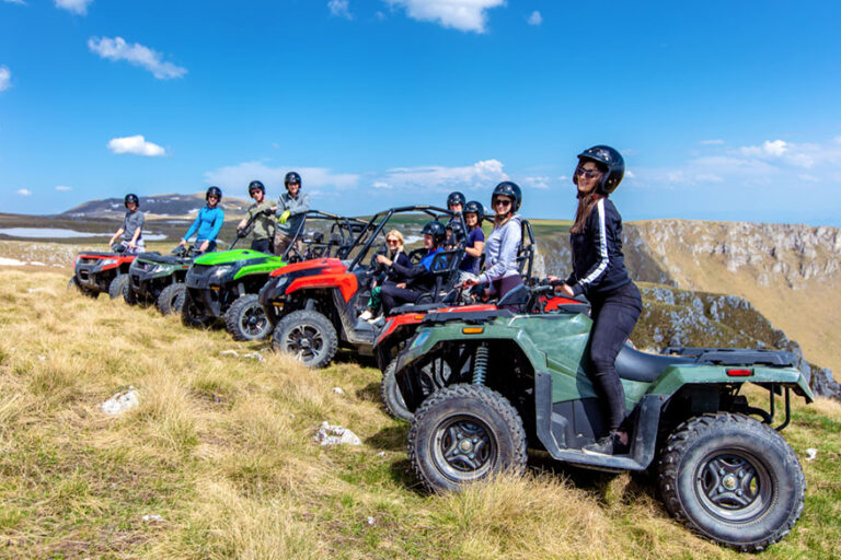 Friends driving off-road with quad bike