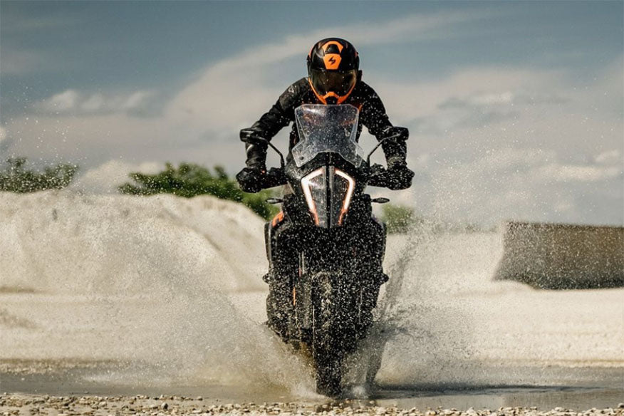 biker riding through water