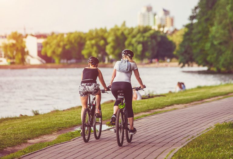 Cyclists ride on the bike path in the city Park