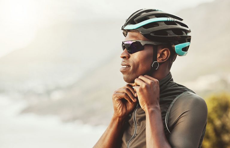 man adjusting bike helmet