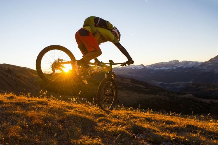mountainbiker jumps in the sunset