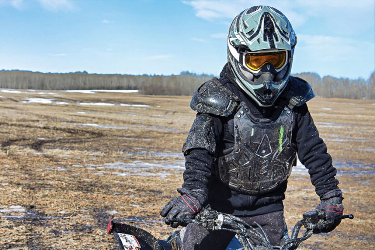 portrait muddy ATV rider