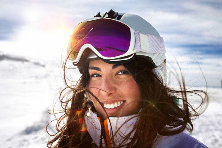 smiling woman in ski helmet