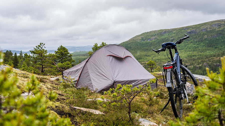 tent bike surrounded by green