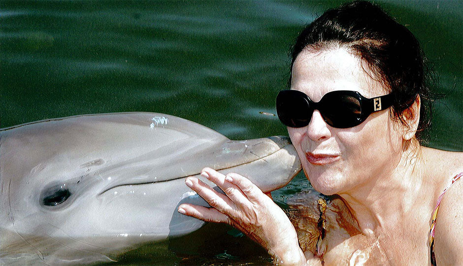Lydia Sarfati swimming with a friendly dolphin