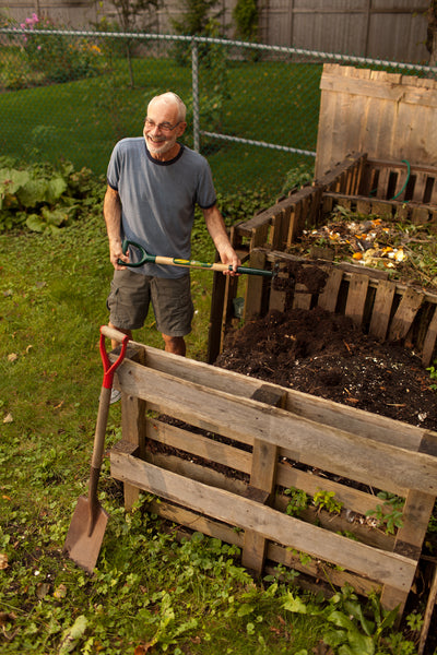 Man tends to Compost Heap near Saint John, New Brunswick