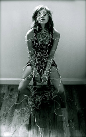 Woman covered in ropes that aren't tied well.