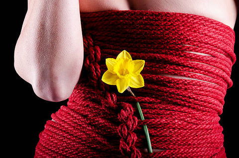 Red bondage rope dress with a yellow flower. 