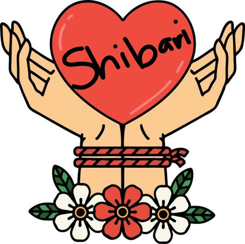 Rope bound hands holding a heart that says Shibari.