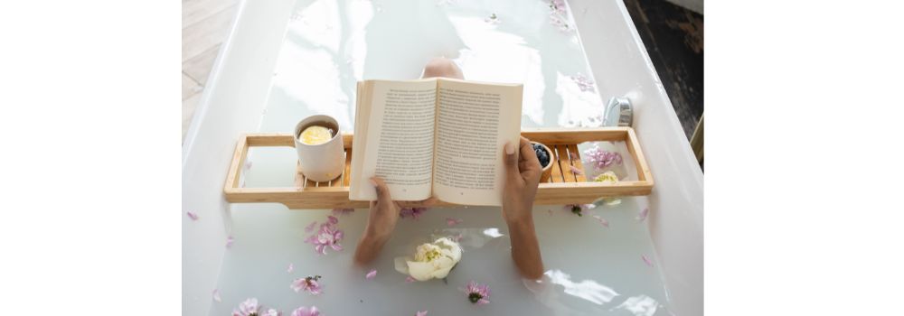 image of bath caddy over a bath with a book resting on it.