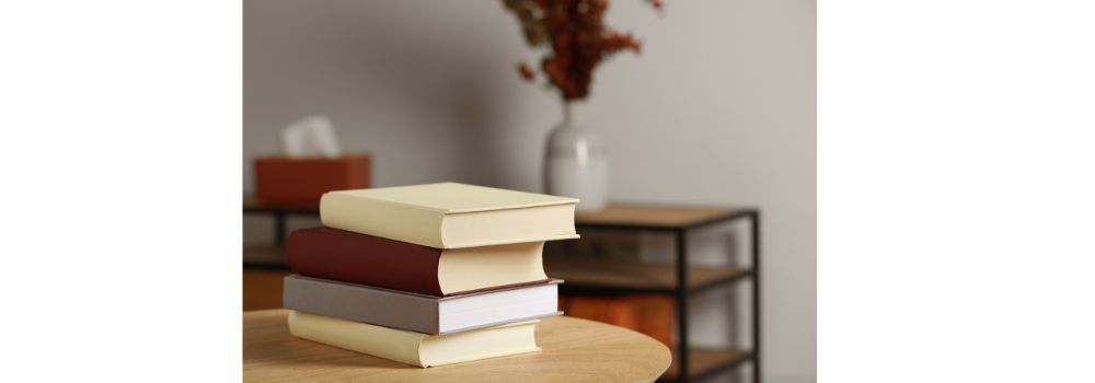 stack of four books on a table