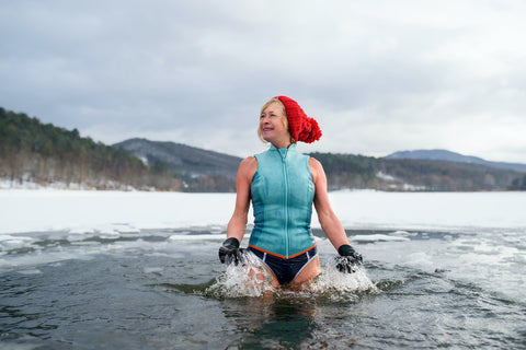 woman in an ice bath. temperature is very cold as there is ice around the late