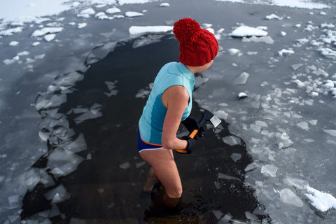 woman breaks ice in water