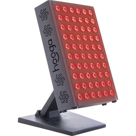 Hooga Pro300 Red light & infrared light therapy device sits on a table top shining a bright red light
