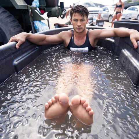 athlete soaks in ice bath following a race