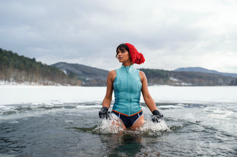woman cold plunging in mountain lake