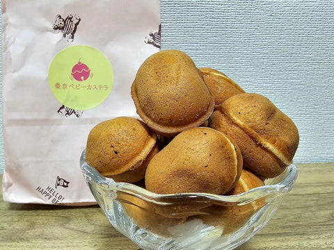 A bowl of plump baby castella cakes from a specialty shop in a glass bowl
