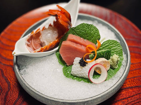 A beautifully arranged plate of sashimi, lobster and more