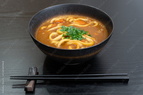 A hearty bowl of udon with a rich curry-based broth