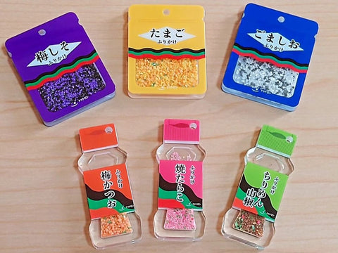 Six mini-packs of different furikake seasoning flavors sit on a table