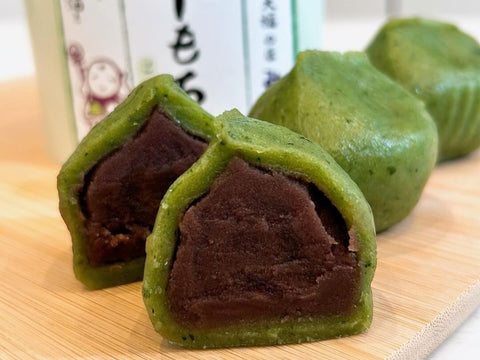 Three daifuku made with green mochi sit on a tray