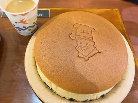 A Rikuro's jiggly cheesecake with a cup of coffee